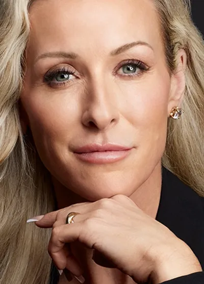 middle aged blond woman smirking at camera